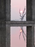 zonsondergang gezien door de peilers van de brug