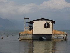 The waterlevel in the lake is getting higher, so there are many house swallowed by the lake