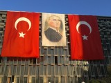 Mustafa Kemal Atatürk, founder of modern Turkey surrounded by Turkish flags