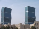 Zig Zag towers behind old style buildings