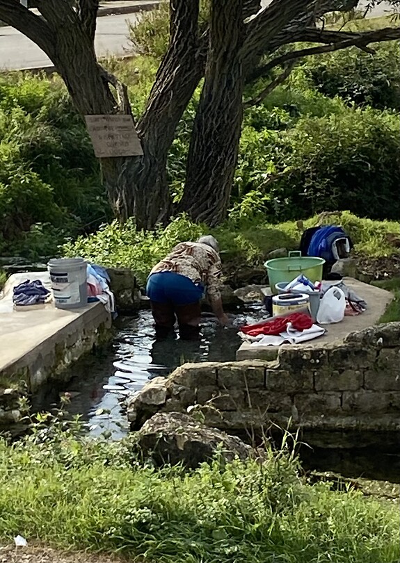 Woman washing clothes in basin