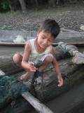 Our little friend Diego showing us the fishes they caught (and that we were to eat that evening) :-)