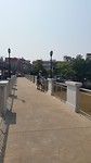 Maggy with her bicycle on the bridge across the Ping.