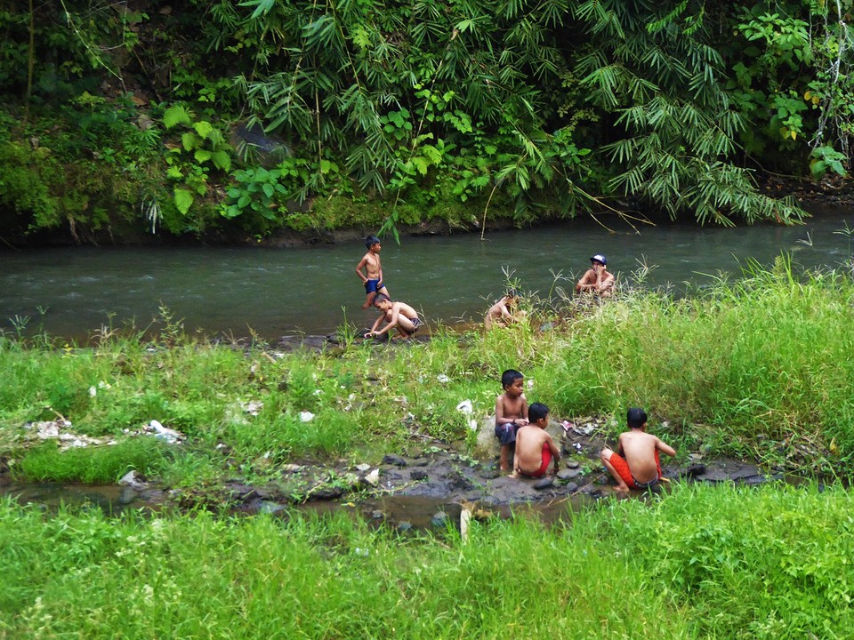 Cute little boys playing down the river