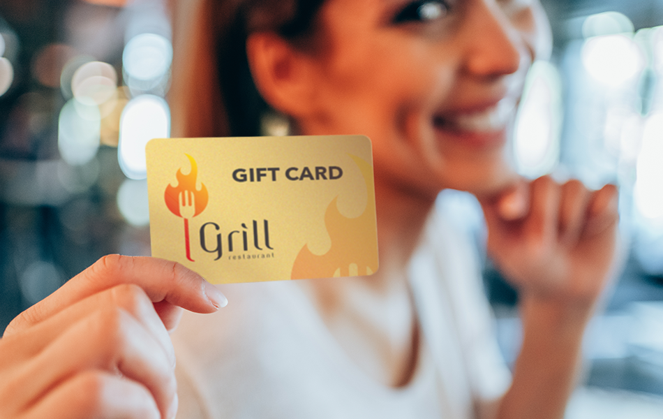 customer loyalty programs smiling customer holding up a restaurant gift card