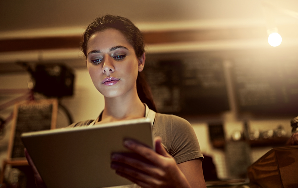 Restaurant customer loyalty program restaurant manager looking at data on a tablet