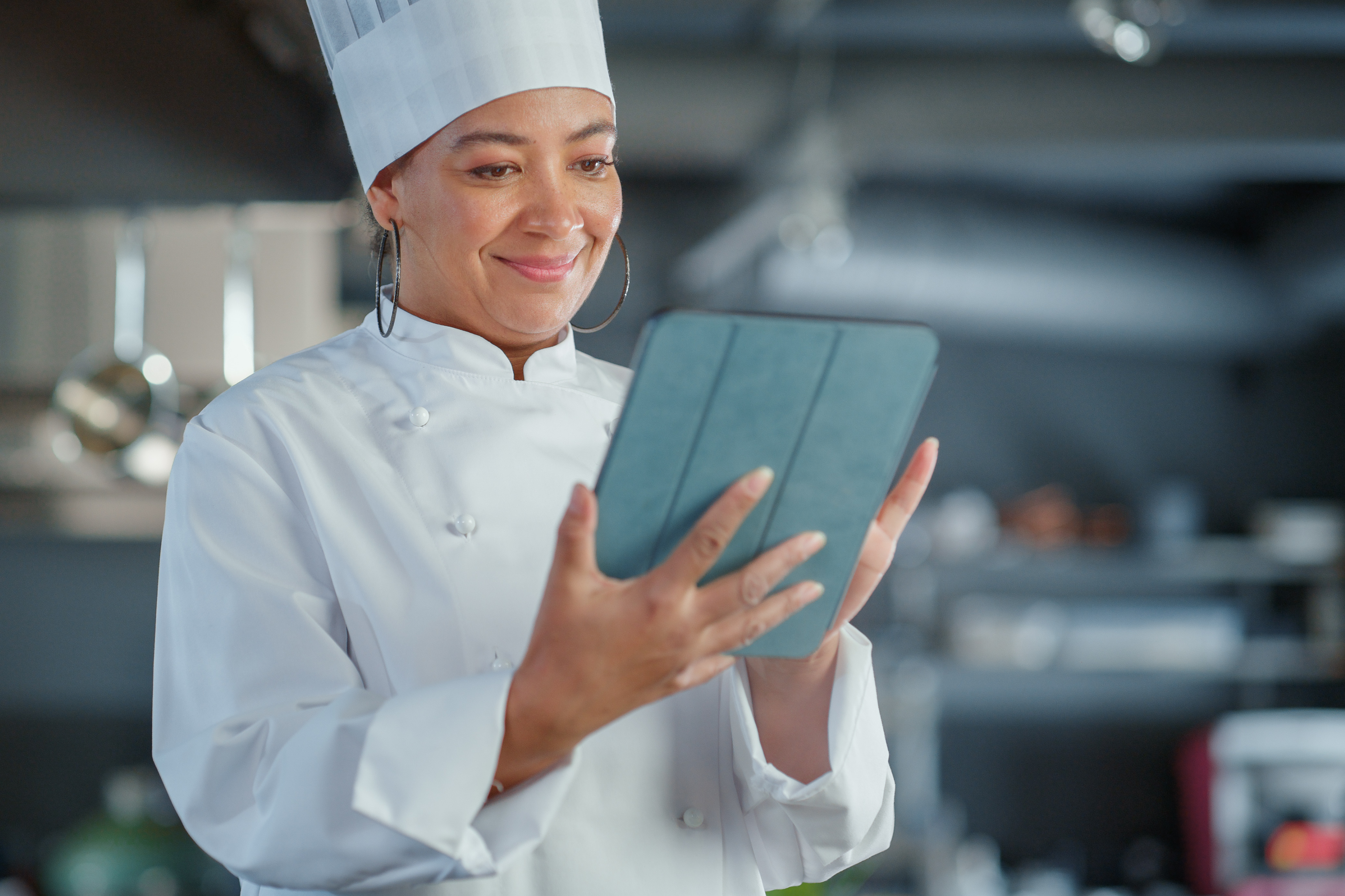 restaurant analytics chef looking at POS reports on a tablet