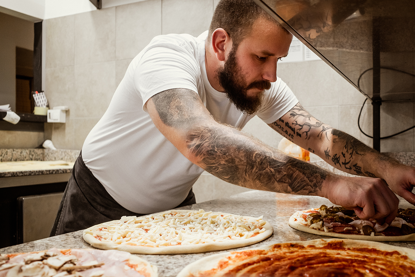 Restaurant POS system pizzeria owner making pies