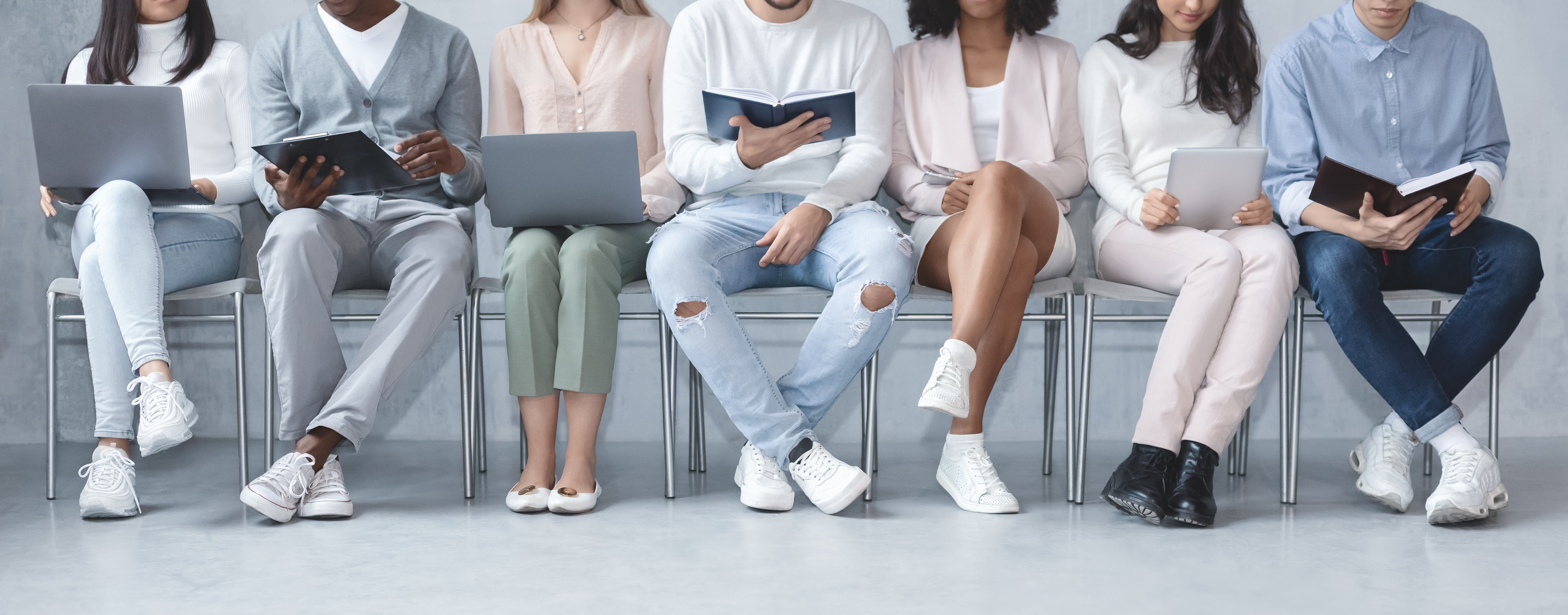 Cropped photo of diverse people sitting in line