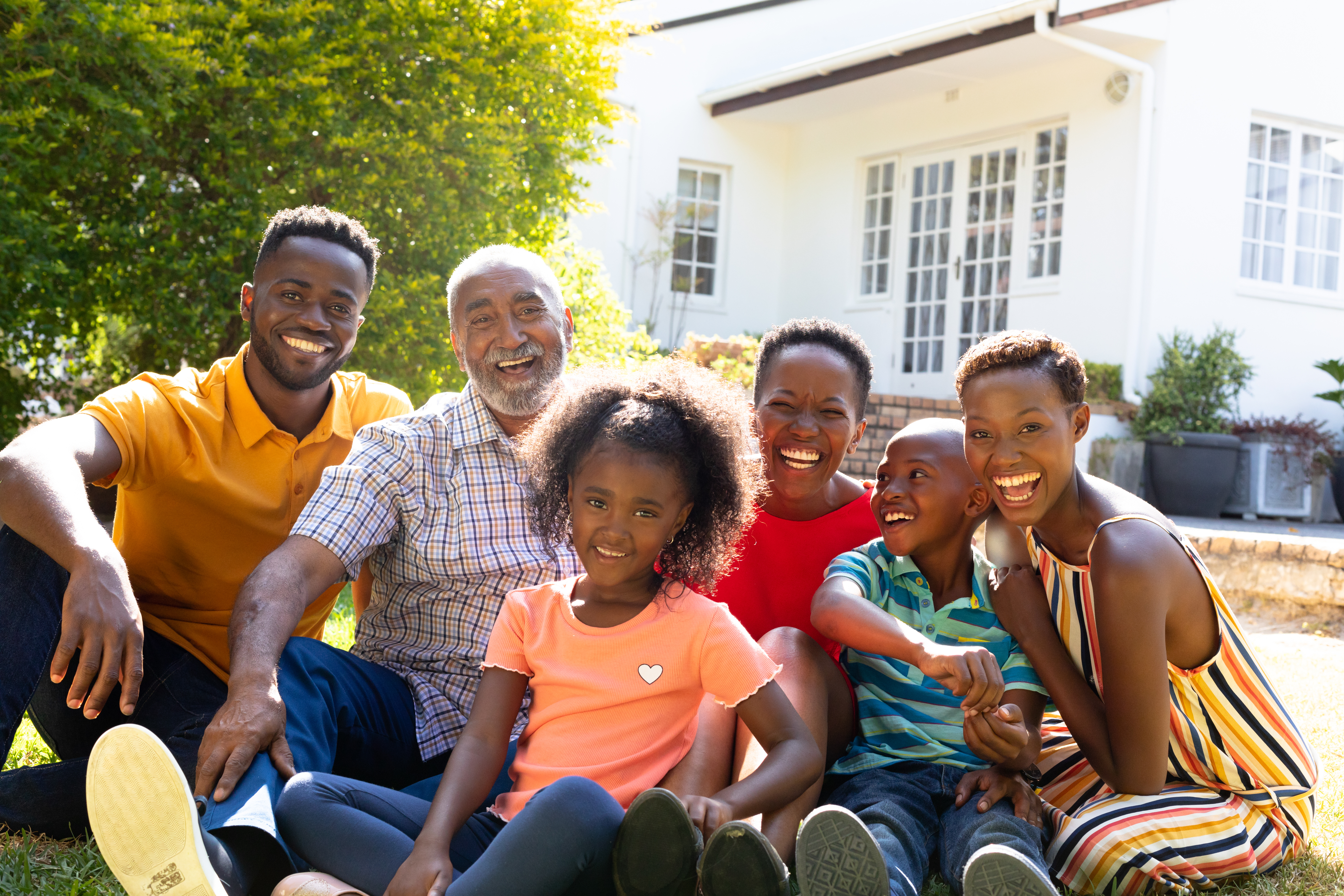 Three generation family spending time together in their garden.