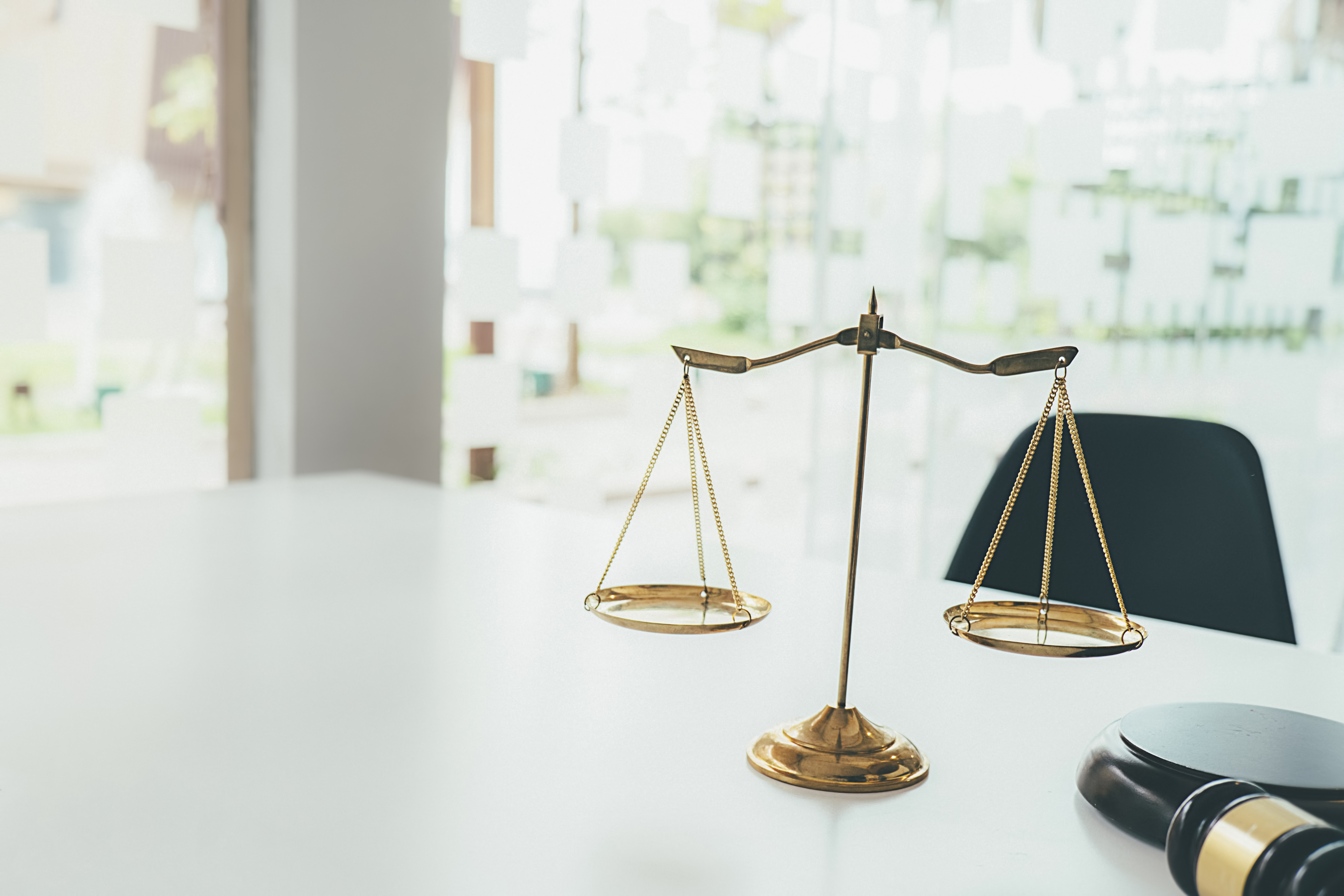 Image of Judge gavel with Justice lawyers having team meeting at law firm background. Concepts of Law and Legal services.
