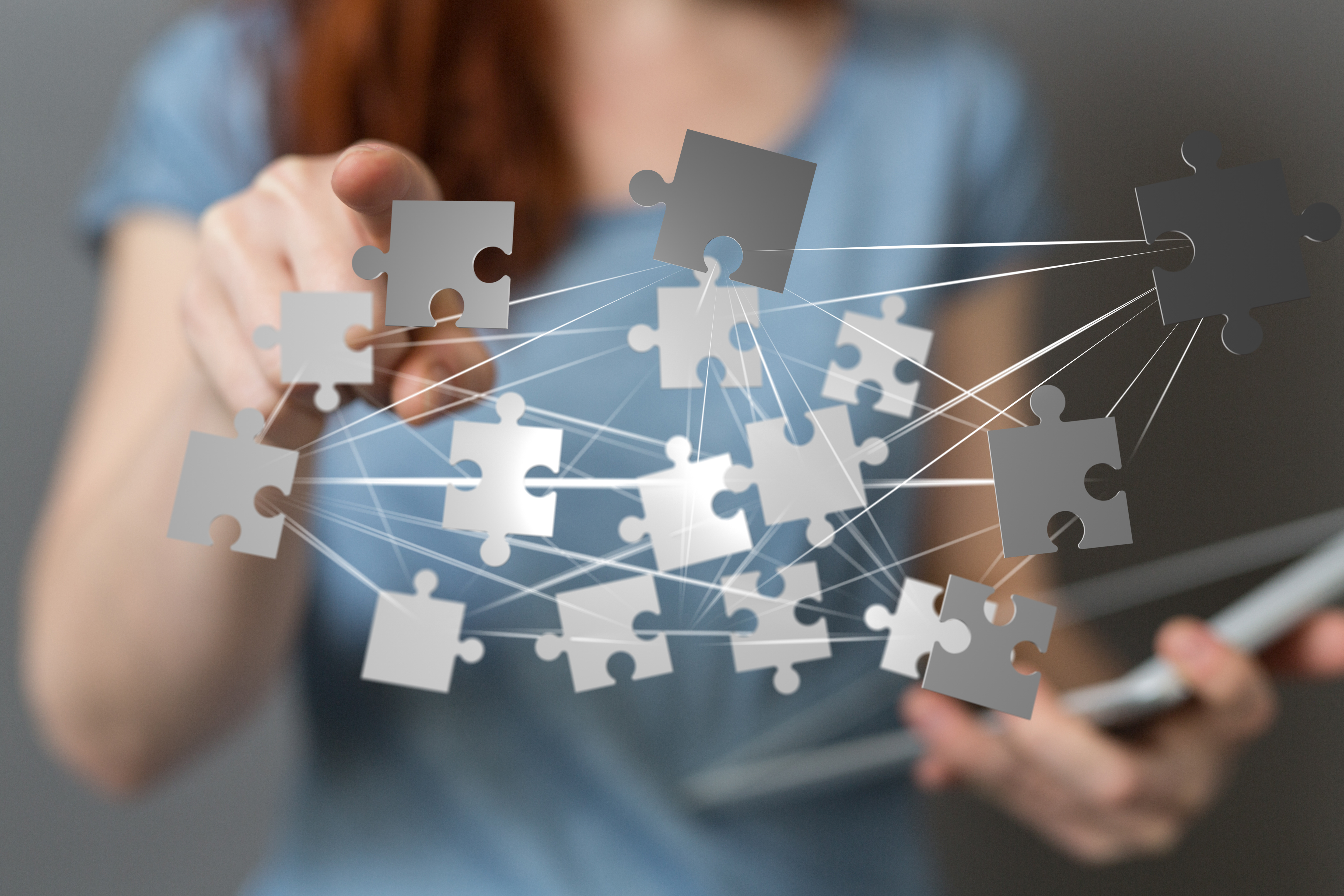 Image of Person rotating puzzle pieces