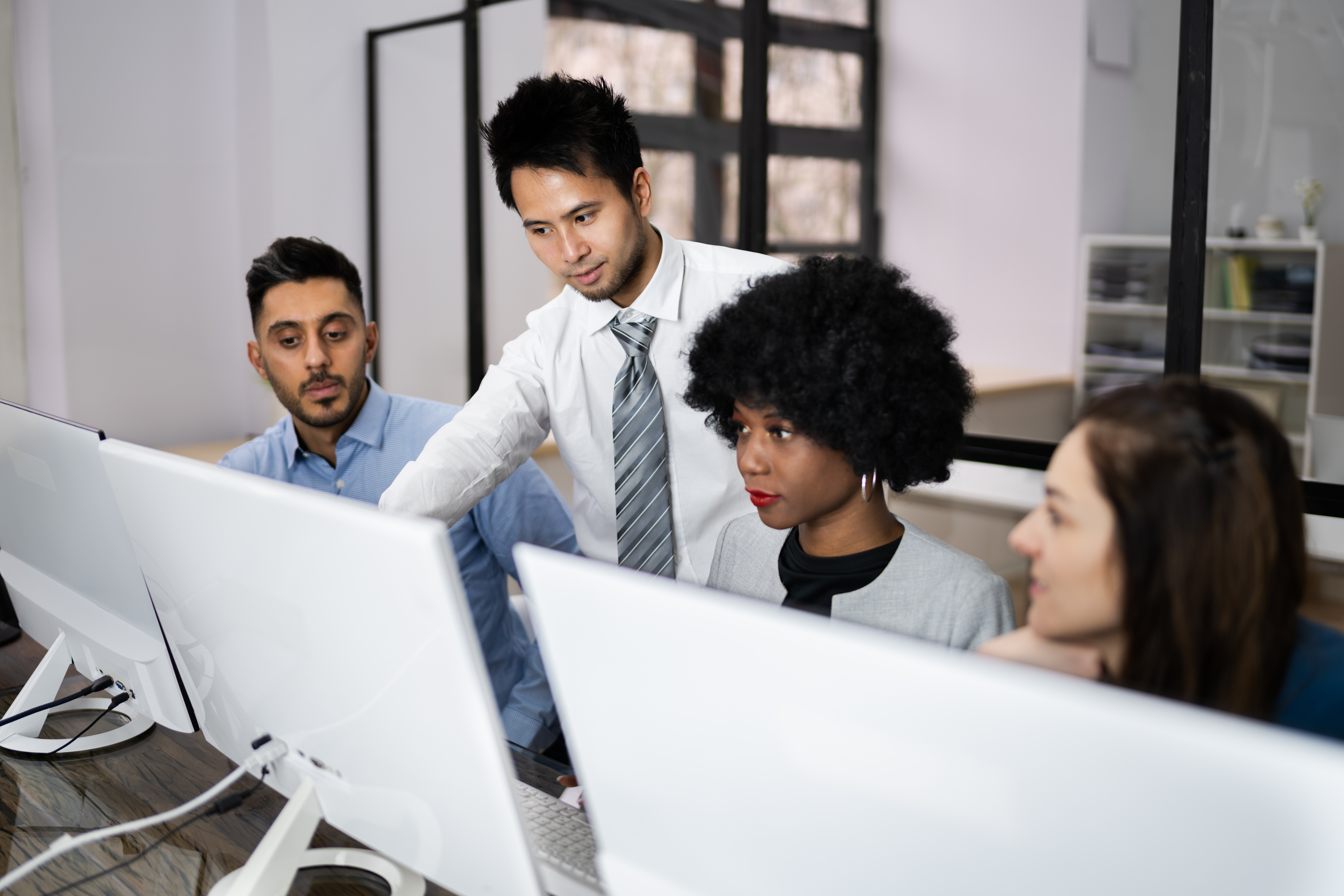Image of Happy Business People Using Laptop Discussing At Workplace