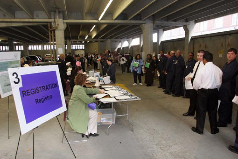 group of people dressed in black standing in a warehouse