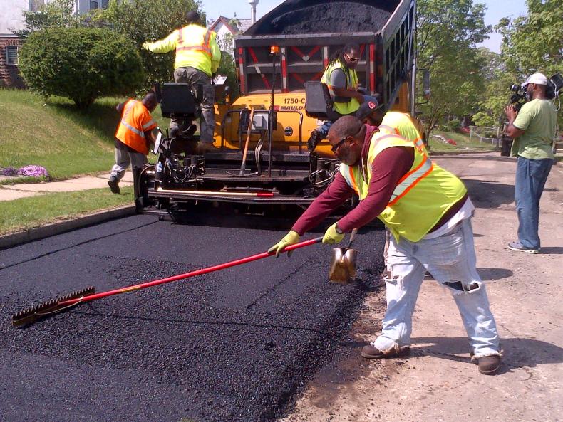 Group of workers paving a road