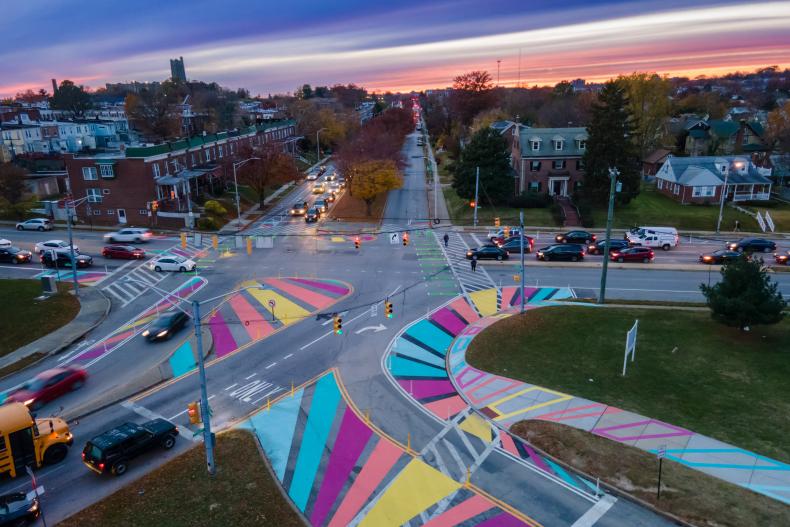 busy intersection with colorfully painted bike lanes