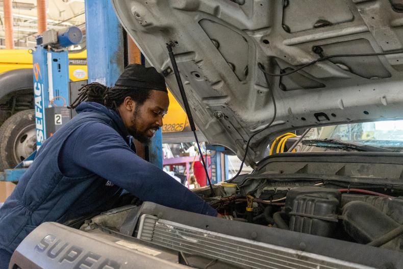 Mechanic works on a truck engine
