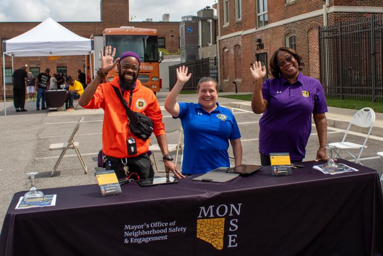 monse team members standing at a table at an event