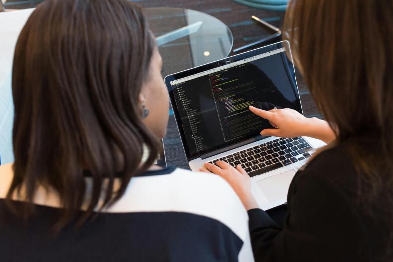 Two people looking at a computer