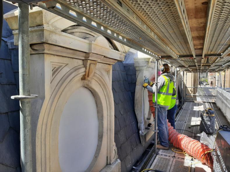 Mason restores historic stone on City Hall