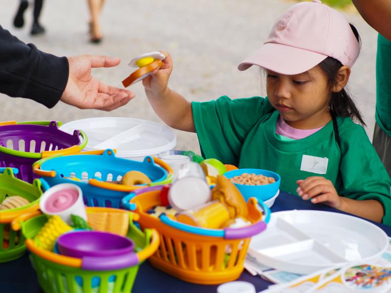 Child playing with plastic food-shaped toys