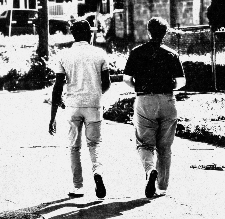 Two men walking down the street