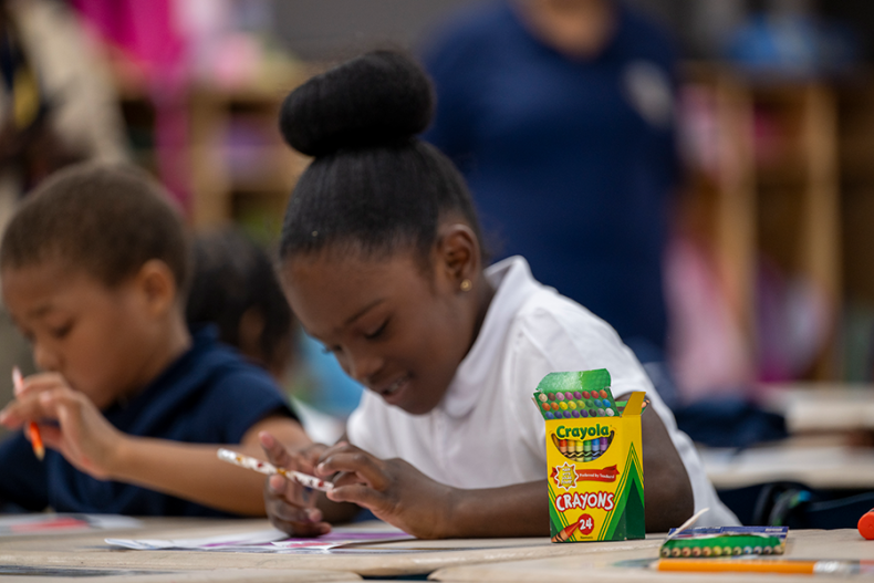 Student working with a coloring book