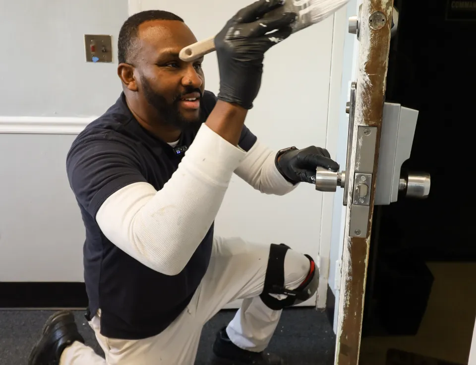 Painter paints a door white