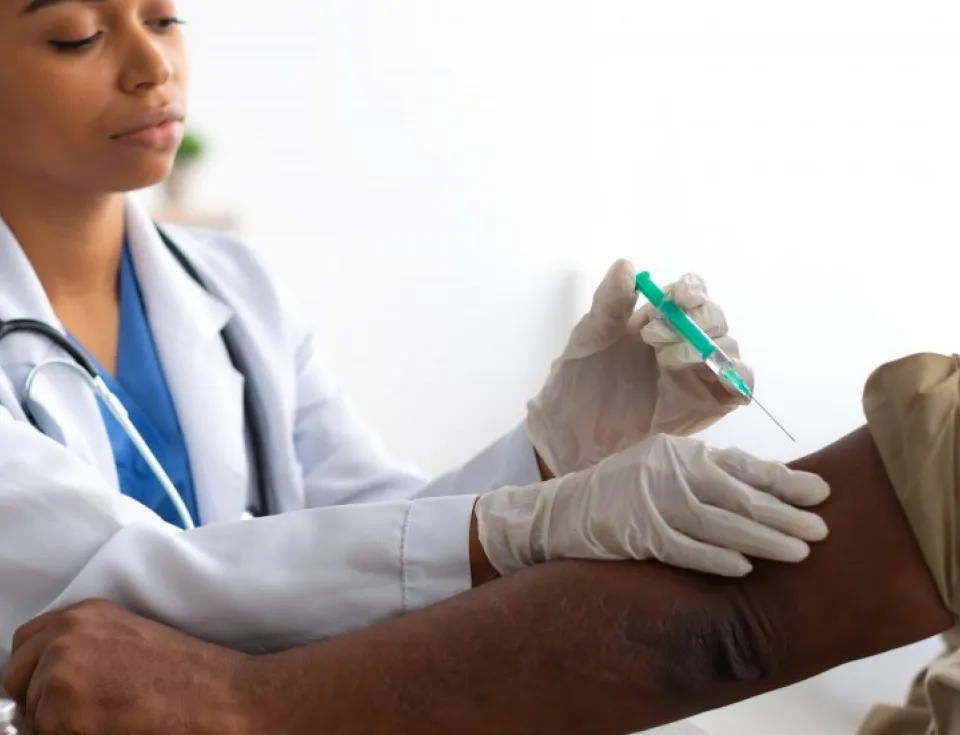Patient receiving a shot in their arm