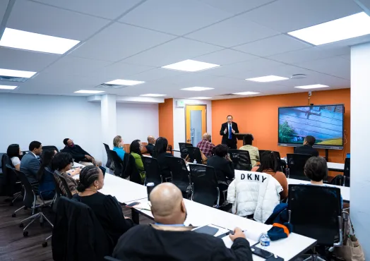 Classroom of adults listening to a presentation