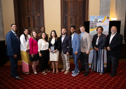 Group of notable City members smiling with an awardee