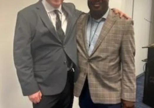Two men pose together