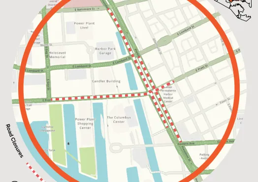 Graphic from the Baltimore City Department of Transportation announcing a road closure at E Pratt Street and President Street on May 2-3, 9 p.m. to 12 p.m. A street map of Baltimore's Inner Harbor area shows the closed intersection marked with red and white dashed lines near landmarks including the Power Plant Live!, Holocaust Memorial, Harbor Park Garage, Candler Building, The Columbus Center, and Kaiser Permanente Harbor Medical Center. The affected area is circled in orange. A small inset map in the uppe