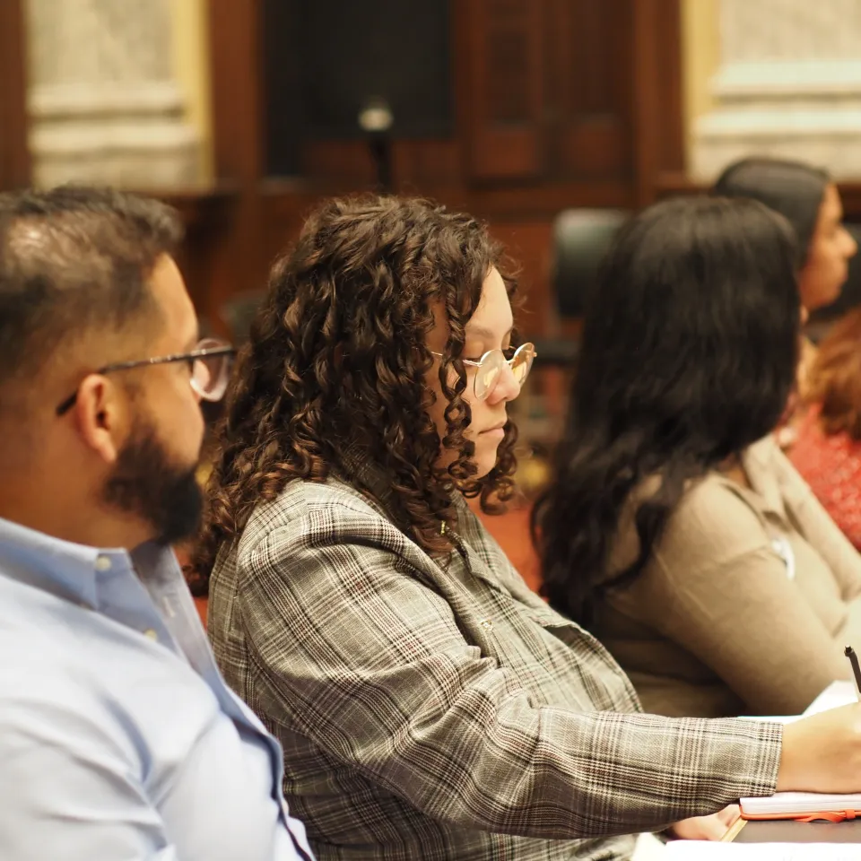New American Leadership Institute participants sit at a table and take notes