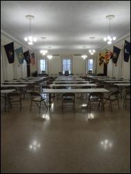 Long shot of a room with tables and chairs in the Assembly Hall