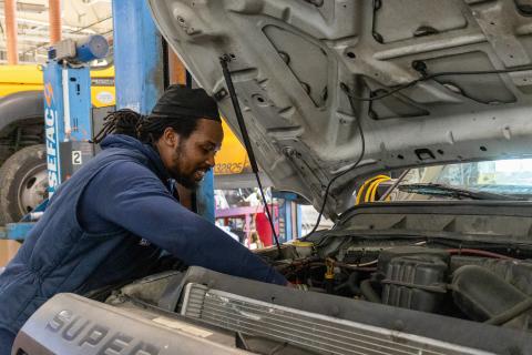 Mechanic works on a truck engine
