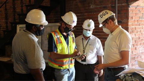 Men in hard hats review construction details