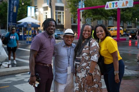 group photo of four people at an outdoor event