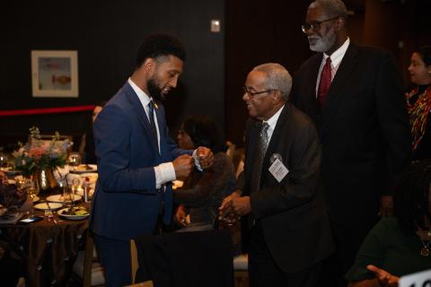 mayor brandon talking to a man at an indoor event