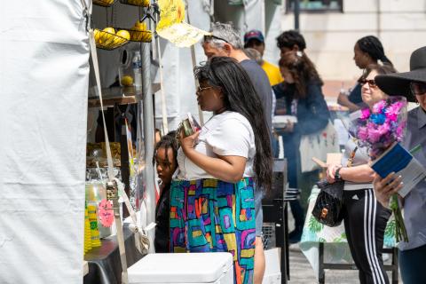 woman looking at fruit at a farmer's market