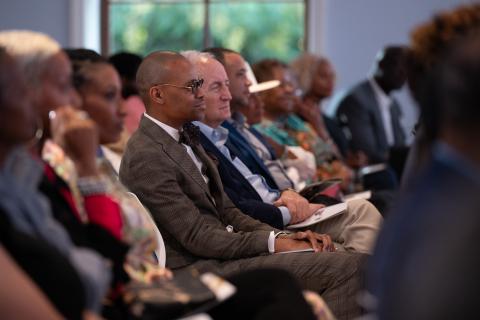 row of people seated an indoor event