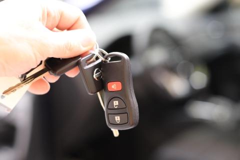 Person handing over car keys