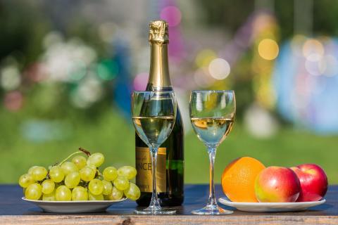 Bottle of wine with two glasses of wine and fruit