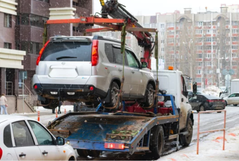car on a flatbed tow truck