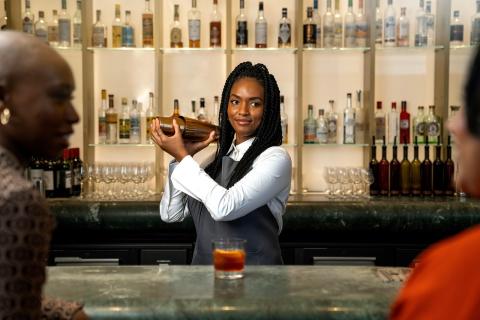woman bartender mixing a drink