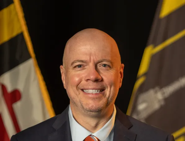 Headshot of Chief Information Officer TJ Mayotte, wearing a suit and tie