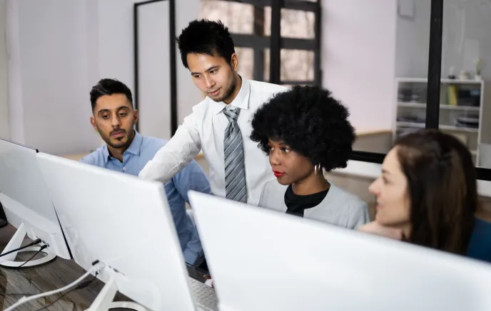 Image of Happy Business People Using Laptop Discussing At Workplace