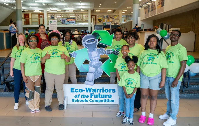 Students and teachers at a school posing for the Eco-Warriors Competition