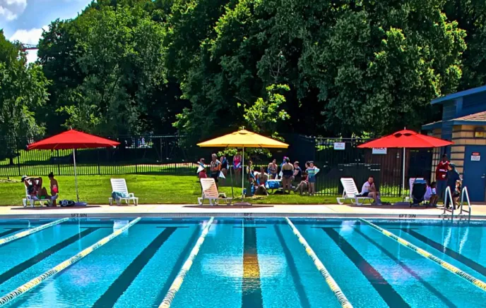 People near a pool on a sunny day