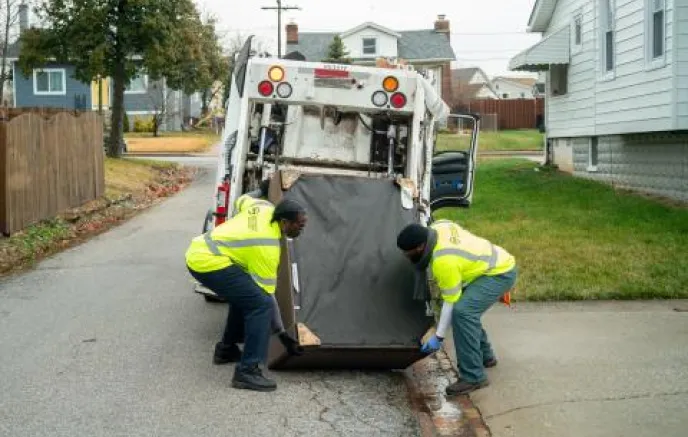city workers moving bulk trash